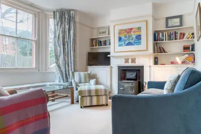 a living room with two chairs and a fireplace at 3 Bed in Aldeburgh oc-f32700 in Aldeburgh