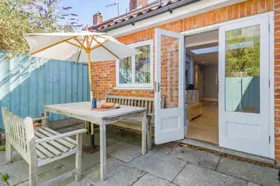 a patio with an umbrella and a table and chairs at 3 Bed in Aldeburgh oc-f32700 in Aldeburgh