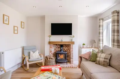 a living room with a fireplace and a tv at 3 Bed in Little Clacton oc-l32526 in Little Clacton