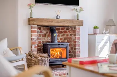a brick fireplace in a living room with a stove at 3 Bed in Little Clacton oc-l32526 in Little Clacton