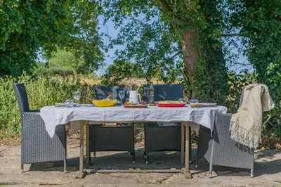 a picnic table with chairs and food on it at 3 Bed in Little Clacton oc-l32526 in Little Clacton