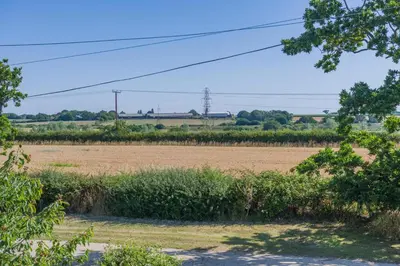 a field with a field of grass and trees at 3 Bed in Little Clacton oc-l32526 in Little Clacton