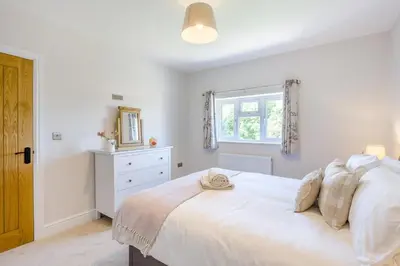 a bedroom with a white bed and a window at 3 Bed in Little Clacton oc-l32526 in Little Clacton