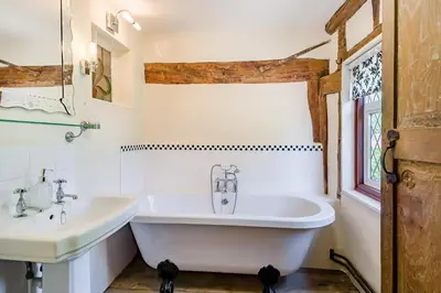 a white bathroom with two sinks and a tub at 4 Bed in St. Nicholas South Elmham oc-o32397 in Saint Margaret