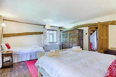 a bedroom with two beds and a window at 4 Bed in St. Nicholas South Elmham oc-o32397 in Saint Margaret