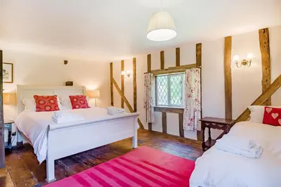 a bedroom with two beds and a window at 4 Bed in St. Nicholas South Elmham oc-o32397 in Saint Margaret