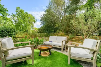 three chairs and a table in a yard at 2 Bed in Dedham oc-c32543 in Dedham