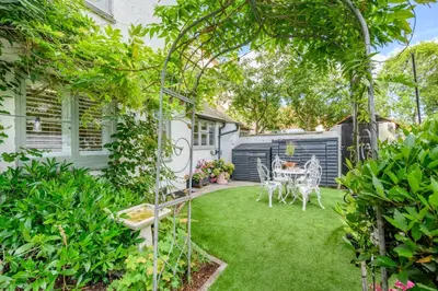 a garden with a table and chairs on the grass at 2 Bed in Dedham oc-c32543 in Dedham