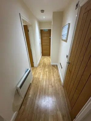 a hallway with a door and a wooden floor at Apartment in Suffolk in Ipswich