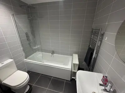 a bathroom with a tub and a toilet and a sink at Apartment in Suffolk in Ipswich