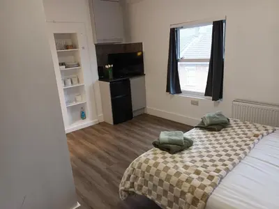 a bedroom with a bed with two pillows on it at Private En-Suite Room by Christchurch Park - room 6 in Ipswich