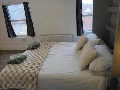 a bedroom with a large bed with pillows on it at Private En-Suite Room by Christchurch Park - room 6 in Ipswich
