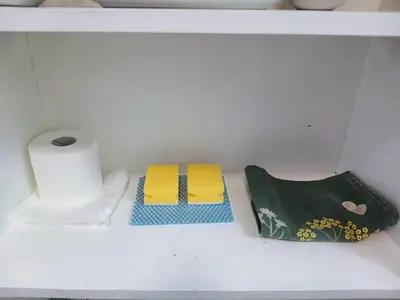 two towels and a roll of toilet paper on a shelf at Private En-Suite Room by Christchurch Park - room 6 in Ipswich