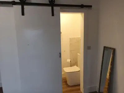 a bathroom with a toilet and a mirror at Private En-Suite Room by Christchurch Park - room 6 in Ipswich