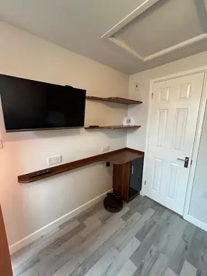 a living room with a flat screen tv on a wall at Somewhere Nice & Cozy in Little Clacton