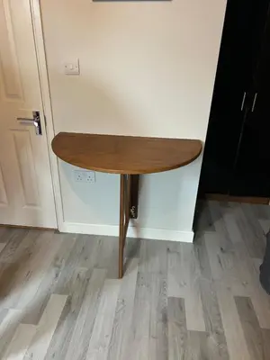 a wooden table in the corner of a room at Somewhere Nice & Cozy in Little Clacton