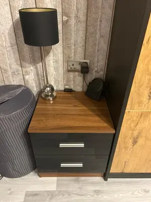 a desk with a lamp on top of a bed at Somewhere Nice & Cozy in Little Clacton