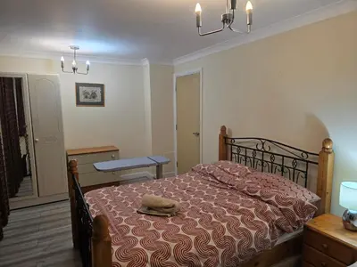 a bedroom with a bed with a hat on it at Colchester chill x1 in Hythe