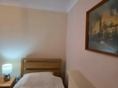 a bedroom with a bed and a painting on the wall at Colchester chill x1 in Hythe