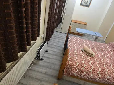 a small bedroom with a bed and a table at Colchester chill x1 in Hythe
