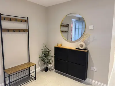 a dressing room with a mirror and a dresser at Central Bury Apartment with Private Entrance in Bury Saint Edmunds