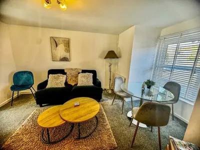 a living room with a couch and a table and chairs at Lime Tree in blue House in Cambridge