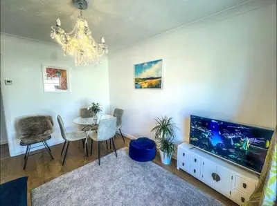 a living room with a table and a large aquarium at Lime Tree in blue House in Cambridge