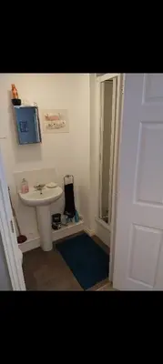 a bathroom with a sink and a tv on the wall at 106 Bradford Drive in Colchester