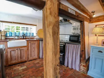 a kitchen with wooden cabinets and a sink at Bank House in Norwich