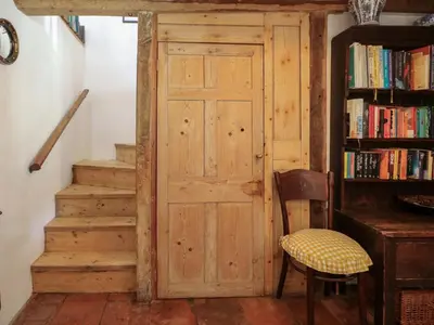 a wooden door in a room with a book shelf at Bank House in Norwich