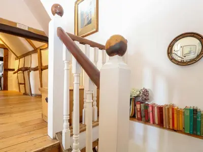 a stairwell with a book shelf with books at Bank House in Norwich