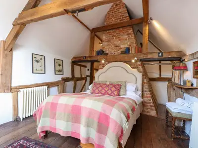 a bedroom with a large bed in a attic at Bank House in Norwich