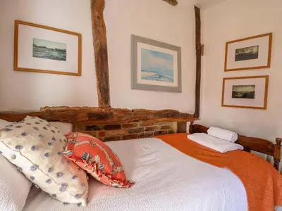 a bedroom with a bed and two pictures on the wall at Bank House in Norwich