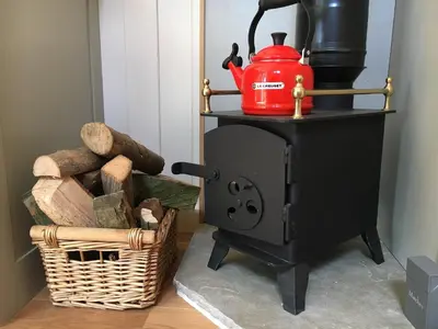 a red kettle on top of a stove at The Scrumpy Shepherd, Brandeston in Blundeston