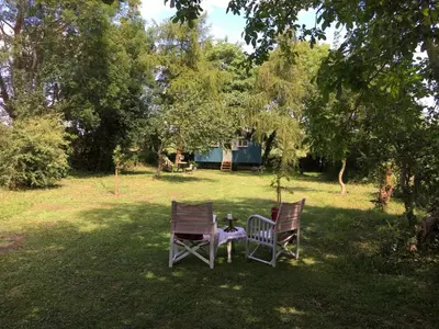 two chairs sitting in the grass in a yard at The Scrumpy Shepherd, Brandeston in Blundeston