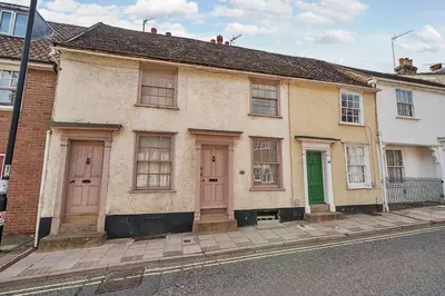 an old house with pink doors on a street at 136 Southgate St, Bury St Edmunds in Bury Saint Edmunds