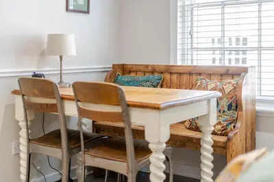 a dining room table with two chairs and a wooden table at 136 Southgate St, Bury St Edmunds in Bury Saint Edmunds