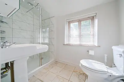 a white bathroom with a toilet and a sink at 136 Southgate St, Bury St Edmunds in Bury Saint Edmunds