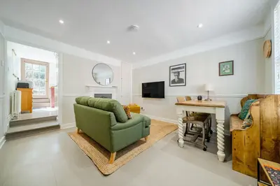 a living room with a green chair and a table at 136 Southgate St, Bury St Edmunds in Bury Saint Edmunds