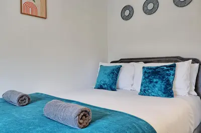 a bedroom with a bed with towels on it at Spacious 4BR Townhouse, Sleeps 9, Fast WIFI, FREE PARKING, Contractor friendly in Colchester