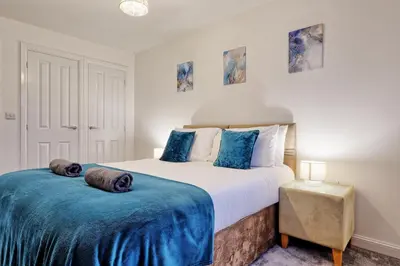 a bedroom with two beds with blue sheets at Spacious 4BR Townhouse, Sleeps 9, Fast WIFI, FREE PARKING, Contractor friendly in Colchester