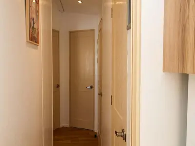 a hallway with a door leading to a room at 21 Poplar Avenue in Felixstowe