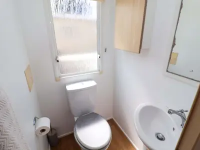 a small bathroom with a toilet and a sink at 21 Poplar Avenue in Felixstowe