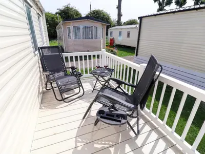 three chairs and a table on a deck at 21 Poplar Avenue in Felixstowe