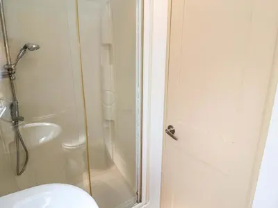 a bathroom with a shower and a toilet at 21 Poplar Avenue in Felixstowe