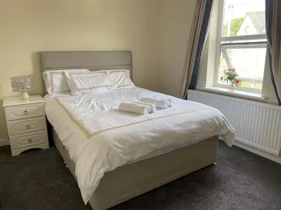 a bedroom with a bed with two towels on it at Gilead Grace House in Littleport