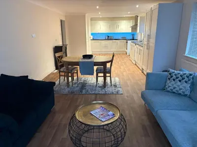 a living room with a couch and a table at Home in Lakenheath in Lakenheath