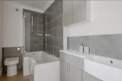 a bathroom with a tub and a toilet and a sink at Amazing Abodes in Chelmsford