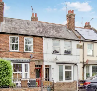 an old brick house with a red door at Amazing Abodes in Chelmsford