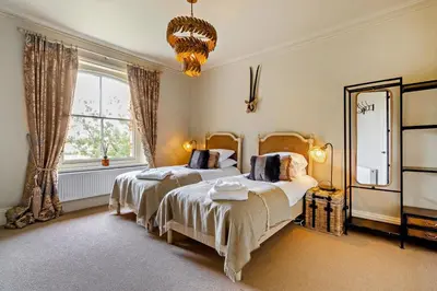 a bedroom with two beds and a large window at 6 Bed in Cowlinge oc-b32762 in Cowlinge